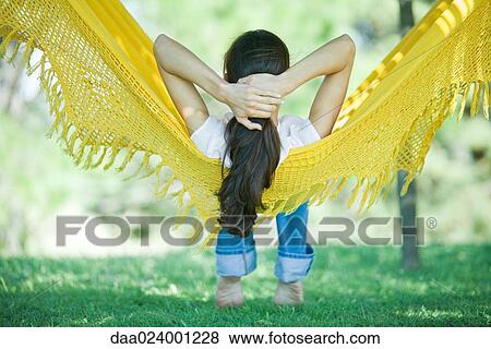Woman resting in hammock sideways, rear view View Large Photo Image Stock Photo - Woman resting in hammock sideways, rear view. Fotosearch