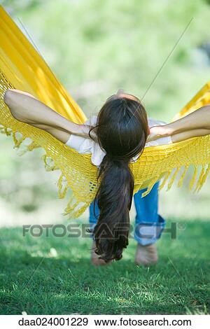 Woman resting in hammock sideways, rear view View Large Photo Image Stock Photo - Woman resting in hammock sideways, rear view. Fotosearch