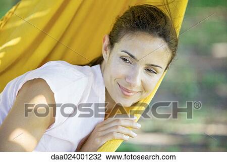 Stock Image - Woman resting in hammock. Fotosearch