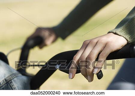 Stock Image - Woman riding bicycle, cropped view. Fotosearch