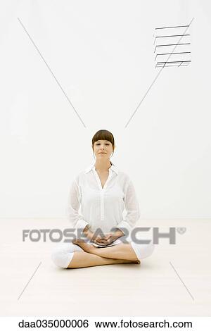 Woman sitting cross-legged, looking at camera, cube floating in midair View Large Photo Image Stock Photograph - Woman sitting cross-legged, looking at camera, cube floating in midair. Fotosearch