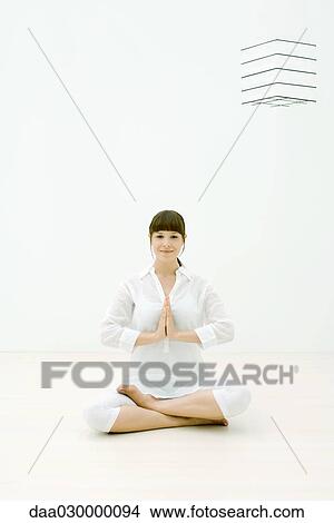 Woman sitting in lotus position on floor, smiling at camera View Large Photo Image Picture - Woman sitting in lotus position on floor, smiling at camera. Fotosearch