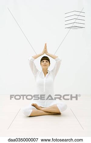 Woman sitting in tree pose on the floor, looking up View Large Photo Image Stock Photo - Woman sitting in tree pose on the floor, looking up. Fotosearch
