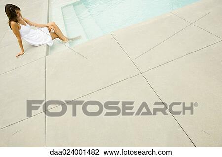 Woman sitting on edge of pool, feet in water, tilt View Large Photo Image Stock Image - Woman sitting on edge of pool, feet in water, tilt. Fotosearch
