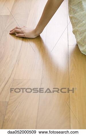 Woman sitting on hardwood floor, cropped View Large Photo Image Stock Photo - Woman sitting on hardwood floor, cropped. Fotosearch