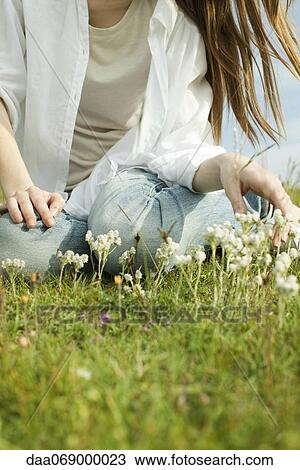 Woman sitting on meadow with wildflowers View Large Photo Image Stock Image - Woman sitting on meadow with wildflowers. Fotosearch