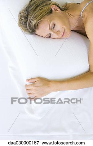 Woman sleeping on comfortable pillow, high angle view View Large Photo Image Stock Photo - Woman sleeping on comfortable pillow, high angle view. Fotosearch