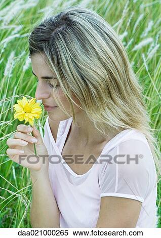 Woman smelling flower View Large Photo Image Stock Photography - Woman smelling flower. Fotosearch