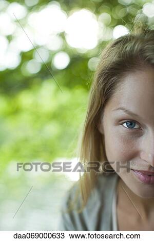 Woman smiling at camera, cropped portrait View Large Photo Image Stock Image - Woman smiling at camera, cropped portrait. Fotosearch