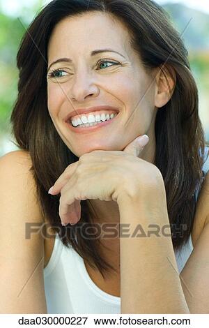 Woman smiling, hand under chin, portrait View Large Photo Image Stock Photo - Woman smiling, hand under chin, portrait. Fotosearch