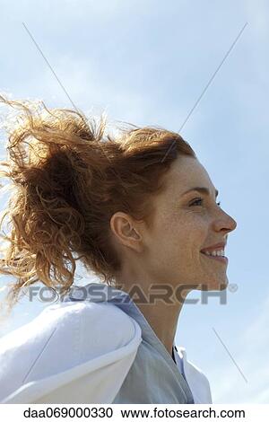 Woman smiling outdoors, profile View Large Photo Image Stock Image - Woman smiling outdoors, profile. Fotosearch