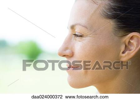Stock Image - Woman smiling, profile. Fotosearch