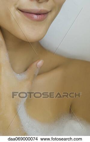 Woman soaking in bubble bath, cropped View Large Photo Image Picture - Woman soaking in bubble bath, cropped. Fotosearch
