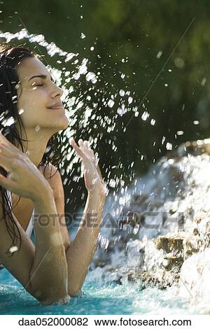 Woman splashing water on self View Large Photo Image Stock Image - Woman splashing water on self. Fotosearch