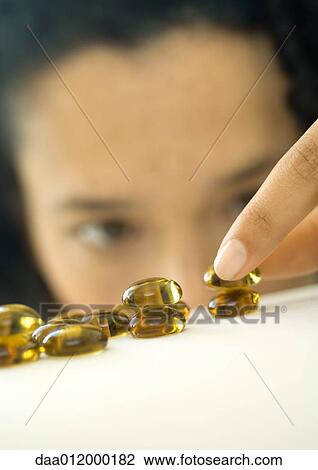 Woman stacking glass pebbles View Large Photo Image Stock Image - Woman stacking glass pebbles. Fotosearch