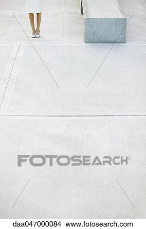 Woman standing in city square, low section View Large Photo Image Picture - Woman standing in city square, low section. Fotosearch