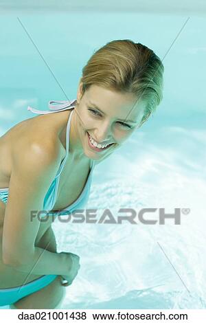 Woman standing in pool, leaning to the side, cropped view View Large Photo Image Stock Photo - Woman standing in pool, leaning to the side, cropped view. Fotosearch