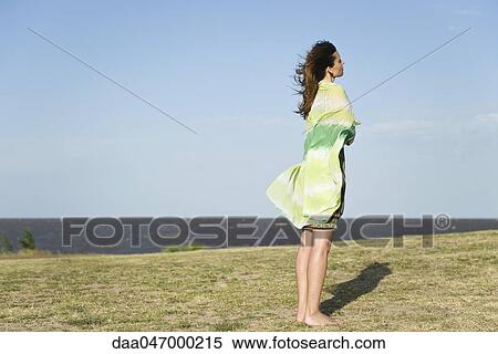 Woman standing outdoors barefoot, wrapped in shawl View Large Photo Image Stock Photography - Woman standing outdoors barefoot, wrapped in shawl. Fotosearch