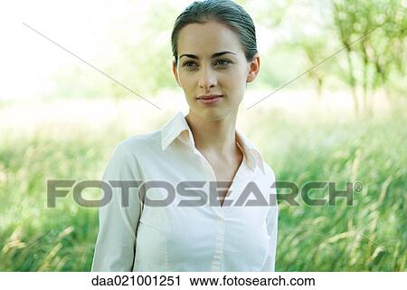Woman standing outdoors, head and shoulders, smiling, portrait View Large Photo Image Stock Image - Woman standing outdoors, head and shoulders, smiling, portrait. Fotosearch