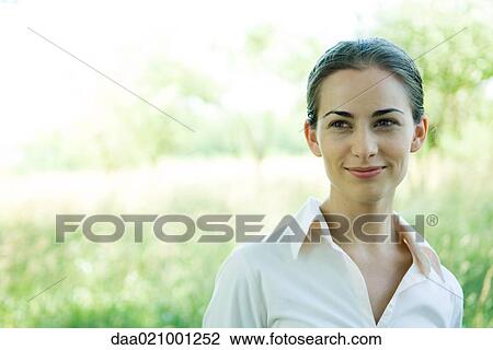 Woman standing outdoors, head and shoulders, smiling, portrait View Large Photo Image Stock Image - Woman standing outdoors, head and shoulders, smiling, portrait. Fotosearch
