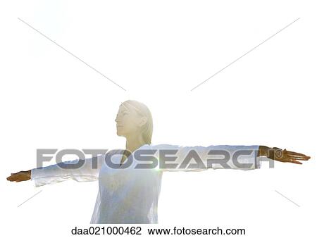 Woman standing with arms out, low angle view, backlit View Large Photo Image Stock Image - Woman standing with arms out, low angle view, backlit. Fotosearch