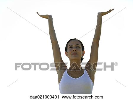 Woman standing with arms up, low angle view View Large Photo Image Stock Image - Woman standing with arms up, low angle view. Fotosearch