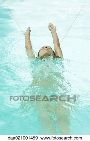Stock Photo - Woman swimming backwards in pool. Fotosearch