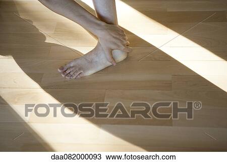 Woman touching ankle, low section, cropped View Large Photo Image Stock Image - Woman touching ankle, low section, cropped. Fotosearch