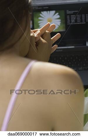 Woman using laptop computer, rear view View Large Photo Image Stock Photo - Woman using laptop computer, rear view. Fotosearch