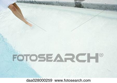 Woman walking in shallow water of swimming pool, cropped, knee down View Large Photo Image Stock Photo - Woman walking in shallow water of swimming pool, cropped, knee down. Fotosearch