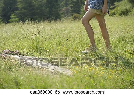 Woman walking on meadow, low section View Large Photo Image Stock Photography - Woman walking on meadow, low section. Fotosearch