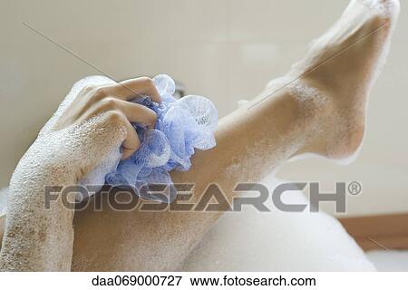 Woman washing leg in bath, cropped View Large Photo Image Stock Photo - Woman washing leg in bath, cropped. Fotosearch