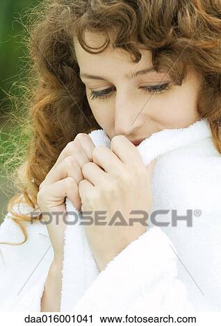 Woman wearing bathrobe, holding up edges of collar View Large Photo Image Stock Image - Woman wearing bathrobe, holding up edges of collar. Fotosearch