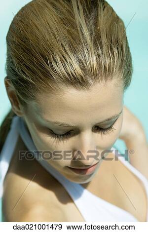 Stock Photo - Woman wearing halter bathing suit, head and shoulders, portrait, high angle view. Fotosearch