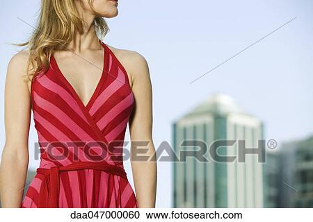 Stock Image - Woman wearing striped halter dress, cropped. Fotosearch