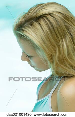 Stock Image - Woman wearing swimsuit, head tilted, high angle, side view. Fotosearch