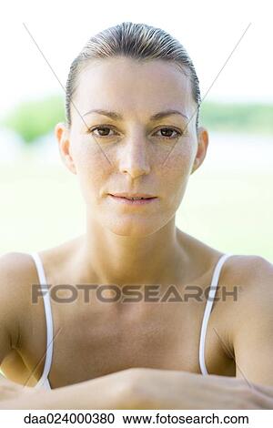Woman wearing tank top, hair back, portrait View Large Photo Image Stock Image - Woman wearing tank top, hair back, portrait. Fotosearch