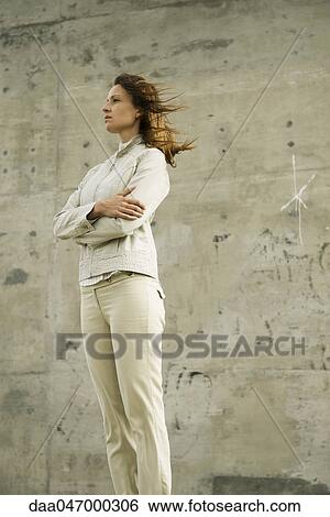 Woman with arms folded, deep in thought, looking away View Large Photo Image Stock Photograph - Woman with arms folded, deep in thought, looking away. Fotosearch
