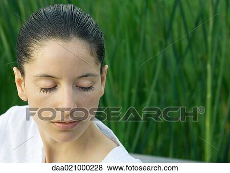 Stock Photo - Woman with eyes closed, head and shoulders, portrait. Fotosearch