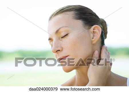 Woman with hand on neck View Large Photo Image Stock Photo - Woman with hand on neck. Fotosearch