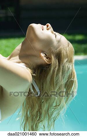 Woman with head back and eyes closed, pool in background View Large Photo Image Stock Image - Woman with head back and eyes closed, pool in background. Fotosearch
