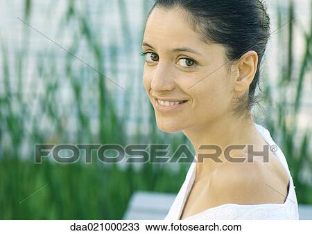 Woman with shirt falling off shoulder smiling at camera View Large Photo Image Stock Image - Woman with shirt falling off shoulder smiling at camera. Fotosearch