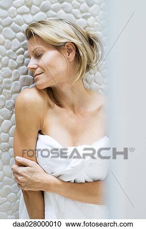 Woman wrapped in towel, leaning chin on shoulder, smiling, eyes closed View Large Photo Image Stock Image - Woman wrapped in towel, leaning chin on shoulder, smiling, eyes closed. Fotosearch