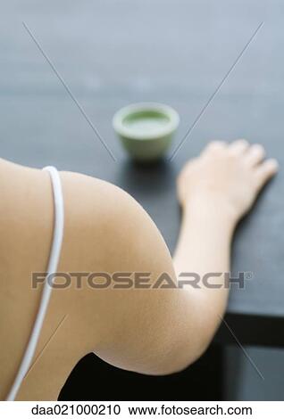 Woman's arm on table next to teacup, cropped view View Large Photo Image Stock Image - Woman's arm on table next to teacup, cropped view. Fotosearch
