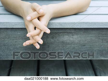 Stock Photo - Woman's clasped hands, close-up. Fotosearch