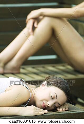 Women relaxing on lounge chairs View Large Photo Image Stock Photography - Women relaxing on lounge chairs. Fotosearch