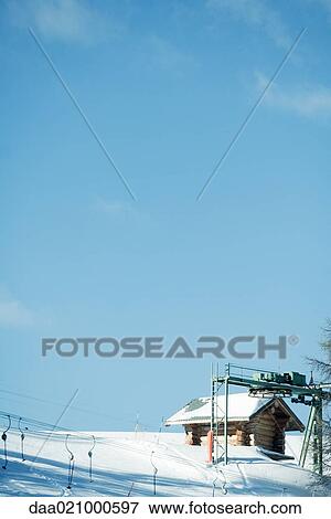 Stock Photo - Wood cabin and ski tows. Fotosearch