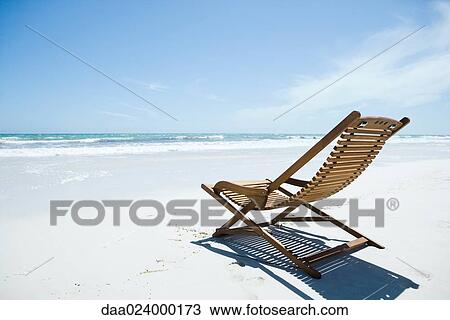 Wooden deckchair on beach View Large Photo Image Stock Image - Wooden deckchair on beach. Fotosearch