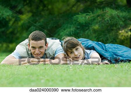 Stock Image - Young campers in sleeping bags. Fotosearch