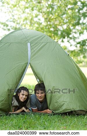 Young campers peeking heads out of tent View Large Photo Image Stock Photo - Young campers peeking heads out of tent. Fotosearch